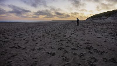 Belgian Aaron Fabrice de Kisangani, 27, searches for abandoned documents by migrants on the beach of Gravelines, north of France. AFP