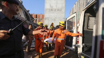 Rescue workers carry the body of a victim. AP Photo