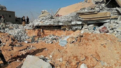 Fighters from the Kataib Hezbollah inspect the destruction of their headquarters. AP Photo