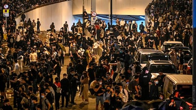 People form a human chain to pass materials as they gather for a march towards Hong Kong Polytechnic University in the Hung Hom district of Hong Kong on November 18, 2019. AFP
