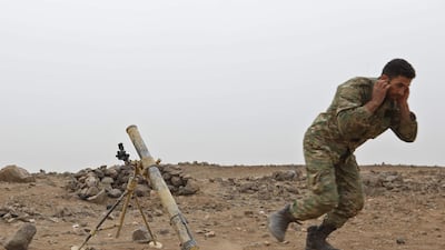 A Syrian rebel fires a mortar during a battle with government forces east of Hama city on November 20, 2017. Explosions were heard at the Hama military airbase on May 18, 2018, just days after rebels in a besieged enclave between Hama and Homs left under an evacuation deal with the government. Omar Haj Kadour / AFP