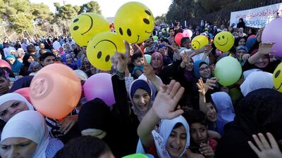Children race to get balloons during Eid Al Fitr celebrations in Amman. Reuters