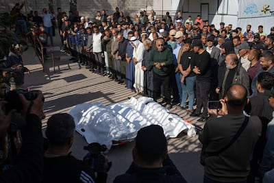 Palestinians pray over the bodies of relatives killed in an Israeli air strike on Khan Younis, southern Gaza. EPA