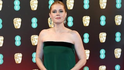 Amy Adams was radiant in an emerald green Tom Ford gown, with velvet trim and a cascading back detail. Karwai Tang / WireImage