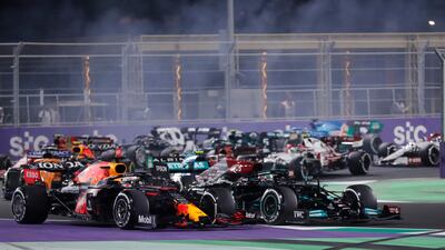 Max Verstappen and Lewis Hamilton compete for the lead. AP