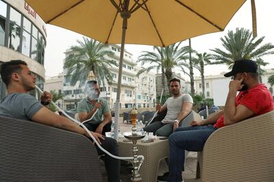 Libyan men smoke water pipe at Saraia cafe in Tripoli. Reuters