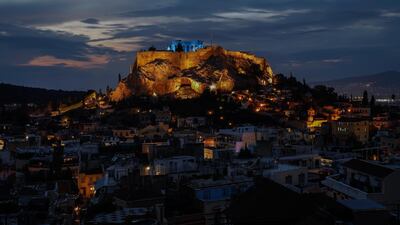 The ancient Parthenon temple atop the Acropolis hill is lit blue during a rehearsal to mark Unicef's World Children's Day in Athens. AP