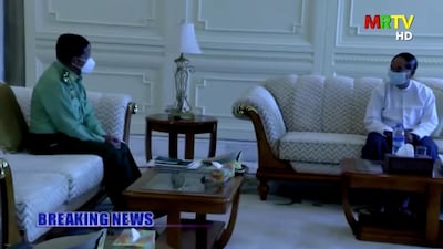 A screen grab from Myanmar state television footage shows Myanmar Acting President Myint Swe (R) and General Min Aung Hlaing (L) as they attend a meeting. Reuters