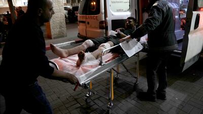 A Palestinian is taken for treatment to the Palestine Medical Complex in the West Bank city of Ramallah on Friday after being wounded in a rampage by Israeli settlers. AP Photo