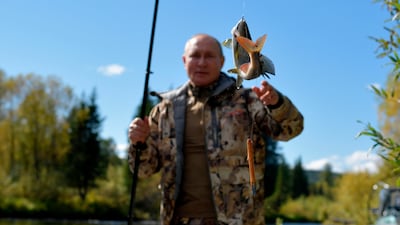 In this undated pool photo released by the Kremlin Press Service via Sputnik on Sunday, Sept. 26, 2021, Russian President Vladimir Putin catches his trophy as he fishes during his and Russian Defense Minister Sergei Shoigu short vacation in early September, 2021 after his working visit to the Primorye and the Amur Region of the Russian Far East. (Alexei Druzhinin, Sputnik, Kremlin Pool Photo via AP)