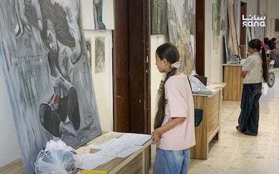 Young visitors view works at the Tafasil exhibition at Azaz Cultural Centre on September 2. Sana