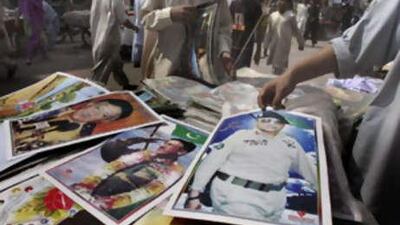 Posters of the Pakistani president Pervez Musharraf are seen on a stall in Lahore.