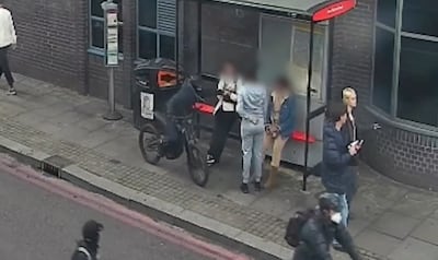 A phone thief on an e-bike snatches a device from an unsuspecting victim. Photo: Metropolitan Police