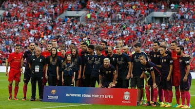 Players from both teams pose for a group photograph ahead of kick-off. Ian Kington / AFP