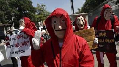 Demonstrators dressed as characters from the Spanish television series 'La Casa de Papel' (Money Heist) flash the three-finger salute and hold placards during a protest against the military coup outside the Russian Embassy in Yangon, Myanmar. People continued to rally across the country despite orders banning mass gatherings and reports of increasing use of force by police against anti-coup protesters. Myanmar's military seized power and declared a state of emergency for one year after arresting State Counselor Aung San Suu Kyi and Myanmar president Win Myint in an early morning raid on 01 February. EPA