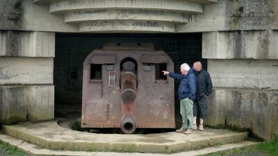 People look at the German guns at the battery at Longues-sur-Mer in Normandy.