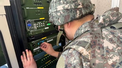 A soldier works on a loudspeaker set up for propaganda broadcasts during a military drill near the demilitarised zone in Paju, South Korea. Reuters