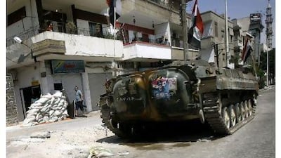 A Syrian tank takes position in a residential street in Homs on Tuesday, as activists reported widespread anti-regime protests across Syria.