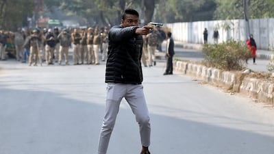 An unidentified man brandishes a gun during a protest against India's new citizenship law outside the Jamia Millia Islamia university in New Delhi in 2017.