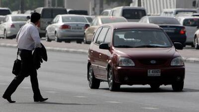 A pedestrian crosses Sheikh Rashid Road between Karama and Zabeel Park in Dubai.