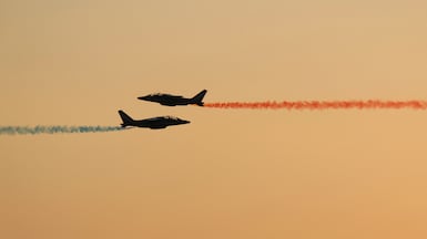 French Air and Space Force's elite flying team 'Patrouille de France' releases trails of blue, white and red smoke in Versailles. AFP