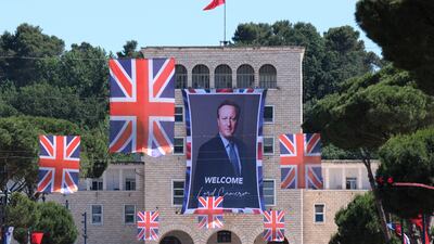 A portrait of British Foreign Secretary David Cameron is attached on a facade at the Tirana University, in Tirana, Albania. AP