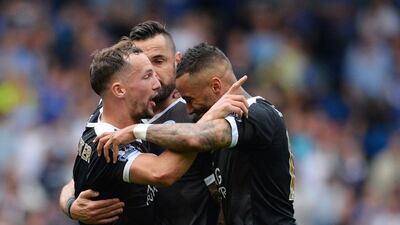 Leicester City’s English midfielder Danny Drinkwater (L) celebrates with teammates after scoring during the Premier League match between Chelsea and Leicester City at Stamford Bridge in London on May 15, 2016. Glyn Kirk / AFP