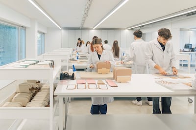 Students at the Academy practising shaping leather around a wooden last. Photo: Prada