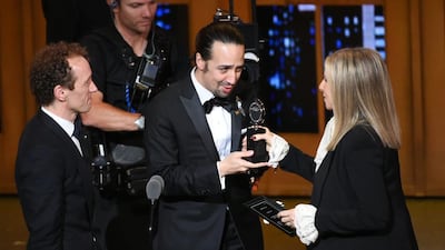 Hamilton producer Jeffrey Seller, left, and creator and star Lin-Manuel Miranda receive the best-musical award from Barbra Streisand. It was one of 11 awards the Broadway show won. Evan Agostini / Invision / AP