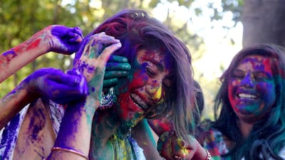 Indian college girls apply powdered color on each other as they take part in Holi festival celebrations in Bhopal, India, 28 Feburary 2018. EPA
