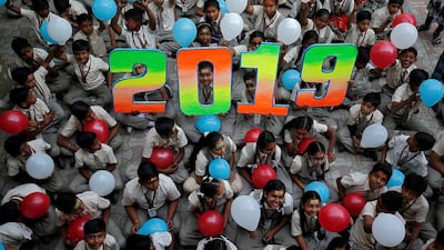 Schoolchildren hold balloons as they pose during celebrations to welcome the New Year at their school in Ahmedabad, India. Reuters