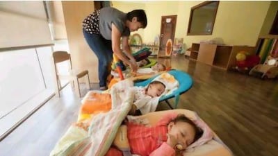 Zenaida Pea, from the Philippines, taking care of children at the Dubai Customs nursery.