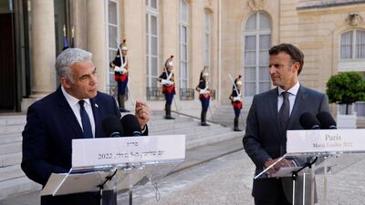 France's President Emmanuel Macron (R) and Israel's Prime Minister Yair Lapid make a statement following their meeting at the Elysee Palace in Paris. AFP