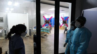 Health workers outside a Covid-19 ward set up at the Commonwealth Games Village Sports Complex in New Delhi. Bloomberg