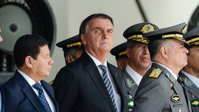 Brazilian President Jair Bolsonaro (C), Vice President Hamilton Mourao (L) and Commander of the Army General Marco Antonio Freire Gomes attend a graduation ceremony for cadets at the Agulhas Negras Military Academy in Resende, Brazil. AFP.