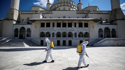Municipality workers in protective suits disinfect the courtyard of the Kocatepe Mosque to prevent the spread of the coronavirus disease, during the holy fasting month of Ramadan in Ankara, Turkey. Reuters