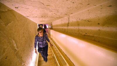 A woman ascends the tunnel leading out of the restored underground tomb. AFP