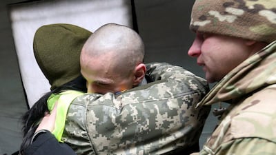 A Ukrainian citizen is welcomed upon his arrival following the exchange of prisoners of war between Ukraine and the separatist republics near the Mayorsk crossing point in Donetsk region. REUTERS