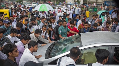 Protesting students block a car to check the vehicle's registration and the driver's license during a rally demanding safe roads on the seventh consecutive day of protests, in Dhaka city, Bangladesh. EPA / MONIRUL ALAM