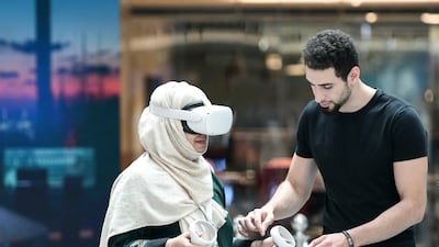 Visitors test VR headsets at the Dubai Metaverse Assembly at Museum of Future. Khushnum Bhandari / The National