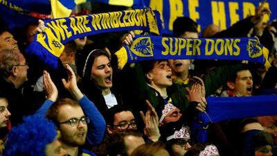 AFC Wimbledon fans cheer on their team during the FA Cup third round match against Liverpool on Monday night. Julian Finney / Getty Images