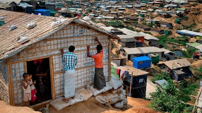 In this April 28, 2018 photo, Rohingya refugees rebuild their makeshift house, in preparation for the approaching monsoon season at the Kutupalong Rohingya refugee camp in Kutupalong, Bangladesh. AM Ahad / AP