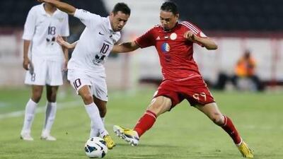 Al Jaish's Karim Ziani challenges Ricardo Oliveira of Al Jazira. Karim Jaafar / AFP
