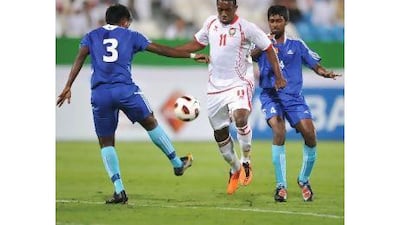 Ahmed Khalil, centre, the UAE striker, in action against Sri Lanka last night. Courtesy of Al Ittihad newspaper
