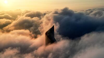 Al Hamra tower in Kuwait's capital rises above heavy fog. AFP