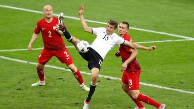 Thomas Muller, in white, accepts he and his fellow German forwards have not fired at Euro 2016 yet. Charles Platiau / Reuters
