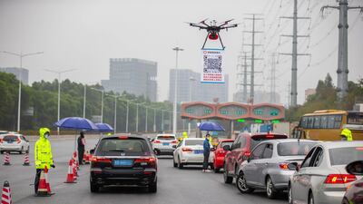 As a measure to help contain coronavirus, an online register system for vehicles coming back to Shenzhen has been put into use since February 8. To increase the efficiency, local police officers used drones to carry a QR code at the expressway exits for drivers to get registered with less contact with other people. Xinhua via AP