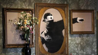 Artworks of British street artist Banksy is displayed in the Walled Off Hotel in the West Bank city of Bethlehem. Abed Al Hashlamoun / EPA