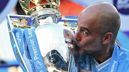(FILES) Manchester City's Spanish manager Pep Guardiola kisses the Premier League trophy after the presentation ceremony following the English Premier League football match between Manchester City and West Ham United at the Etihad Stadium in Manchester, north west England, on May 19, 2024. A press release from the club on May 22, 2026 states: "Manchester City can confirm that Pep Guardiola will step down from his role as Manager this summer. " (Photo by Oli SCARFF / AFP) / RESTRICTED TO EDITORIAL USE. No use with unauthorized audio, video, data, fixture lists, club/league logos or 'live' services. Online in-match use limited to 120 images. An additional 40 images may be used in extra time. No video emulation. Social media in-match use limited to 120 images. An additional 40 images may be used in extra time. No use in betting publications, games or single club/league/player publications. /