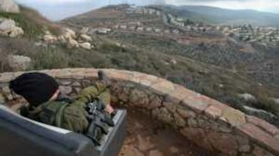An Israeli soldier guards the West Bank Jewish settlement of Elon Moreh near Nablus.
